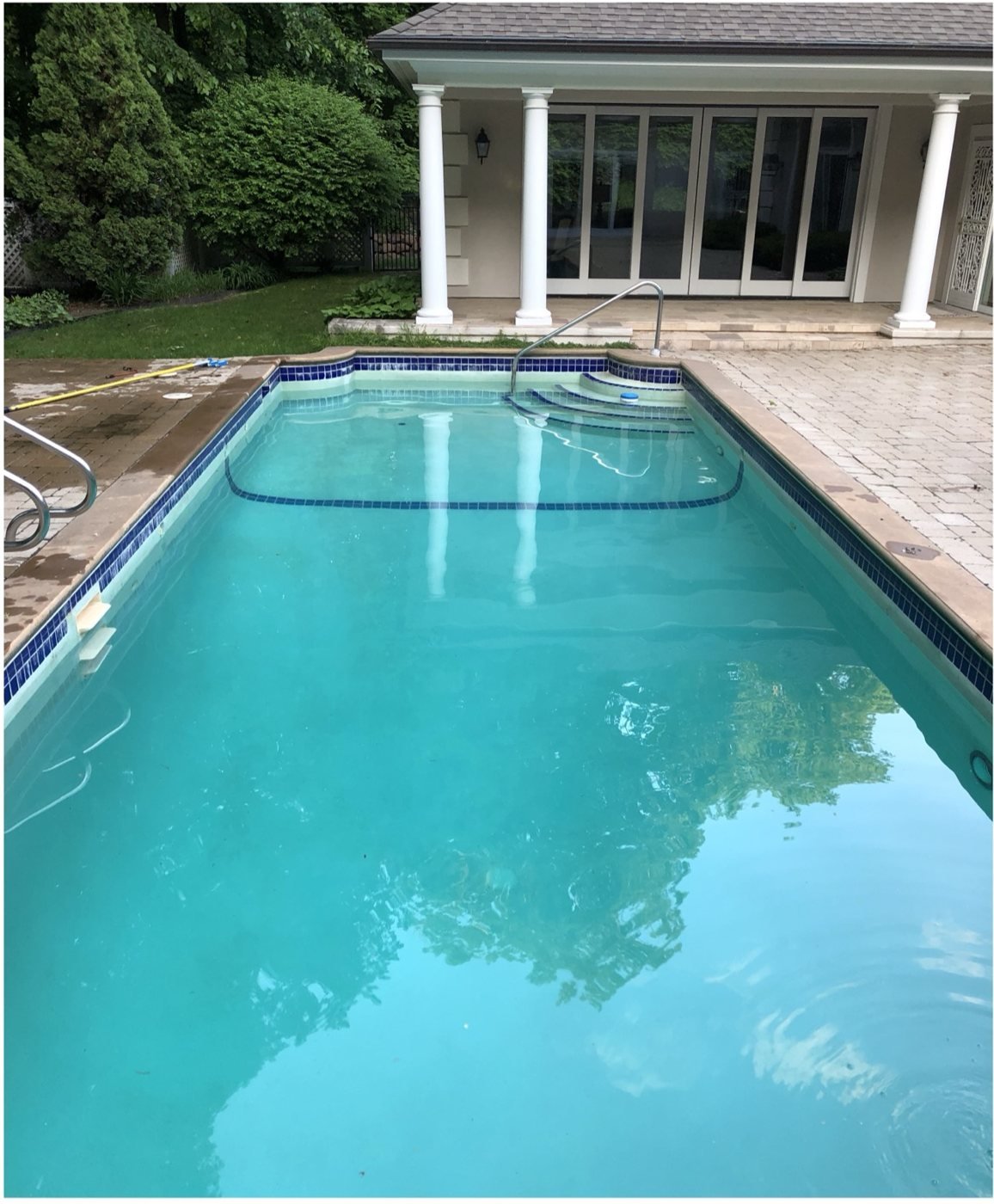 Crystal-clear blue swimming pool after Blue Anchor green-to-clean service in Florissant, MO